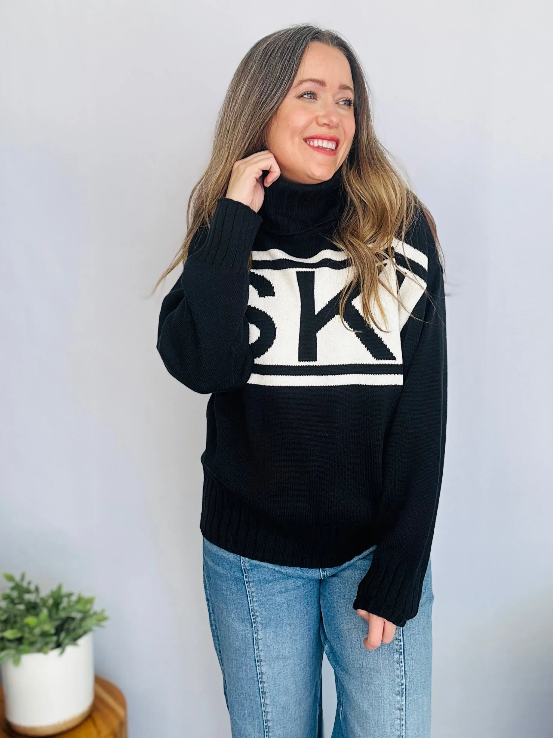Stay Cozy in Style with the SKI Logo Turtleneck Sweater
