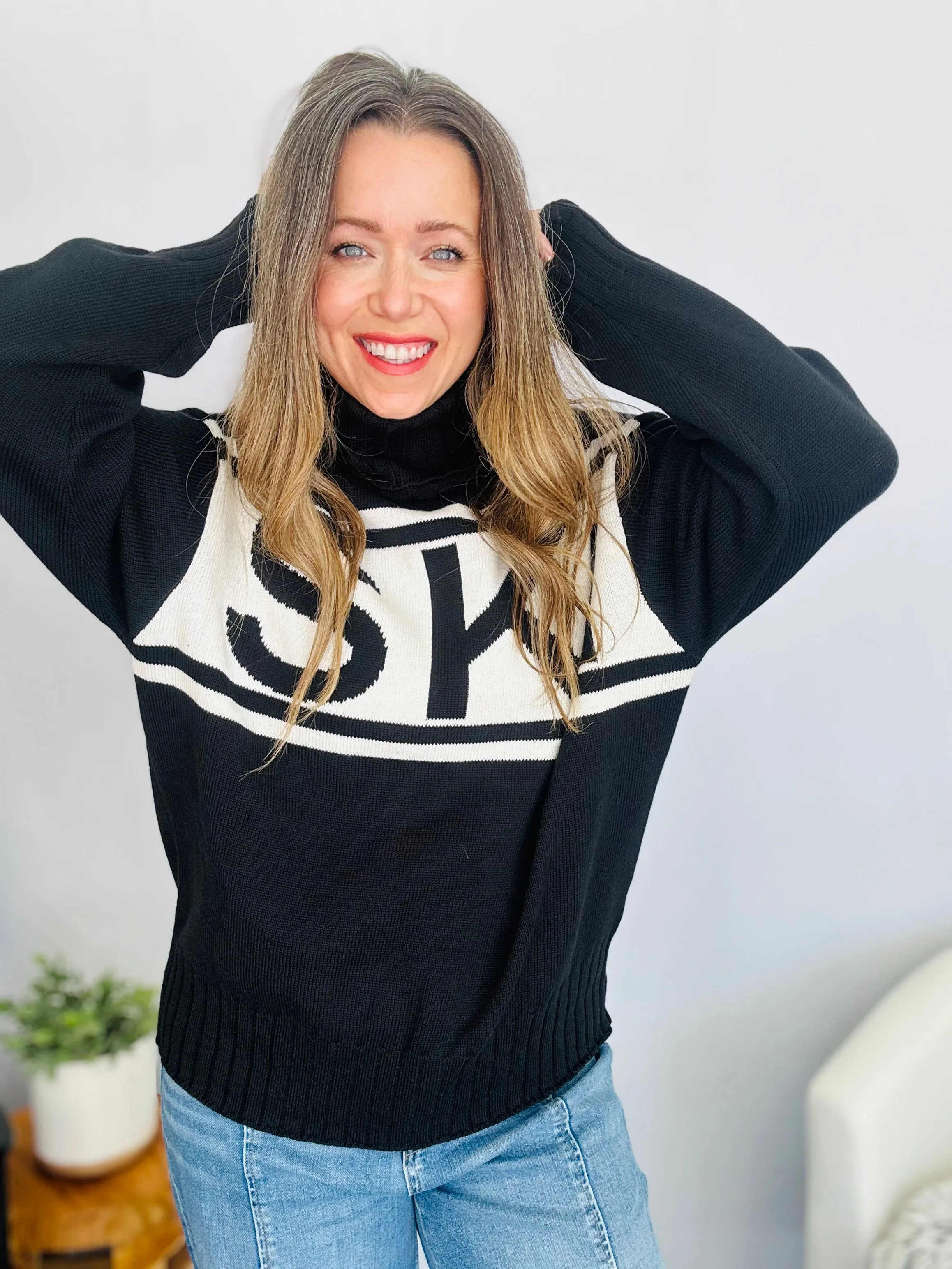 Stay Cozy in Style with the SKI Logo Turtleneck Sweater