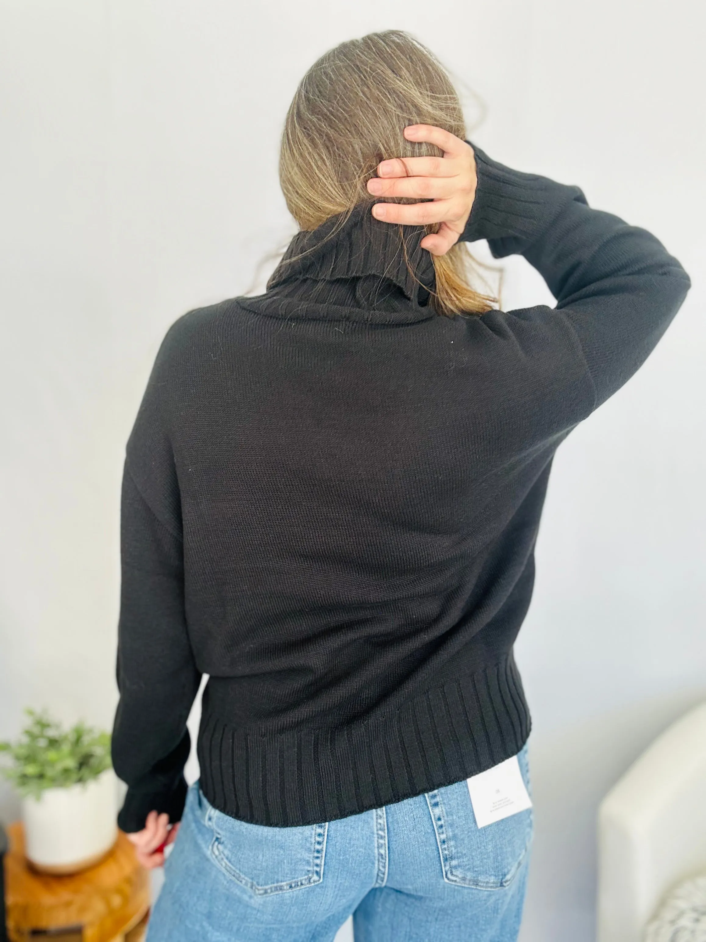 Stay Cozy in Style with the SKI Logo Turtleneck Sweater