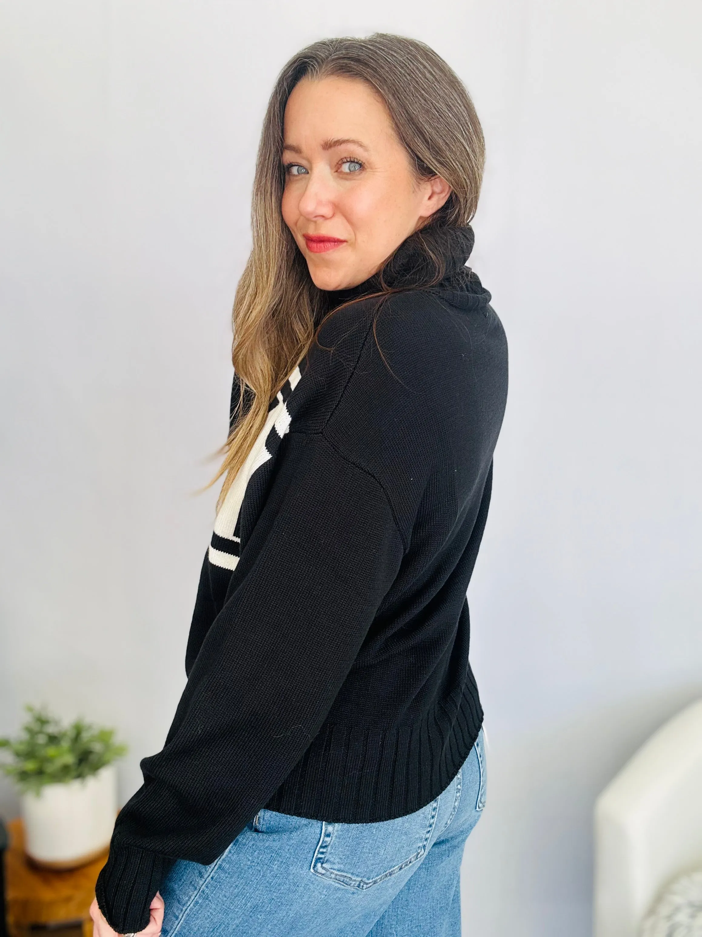 Stay Cozy in Style with the SKI Logo Turtleneck Sweater