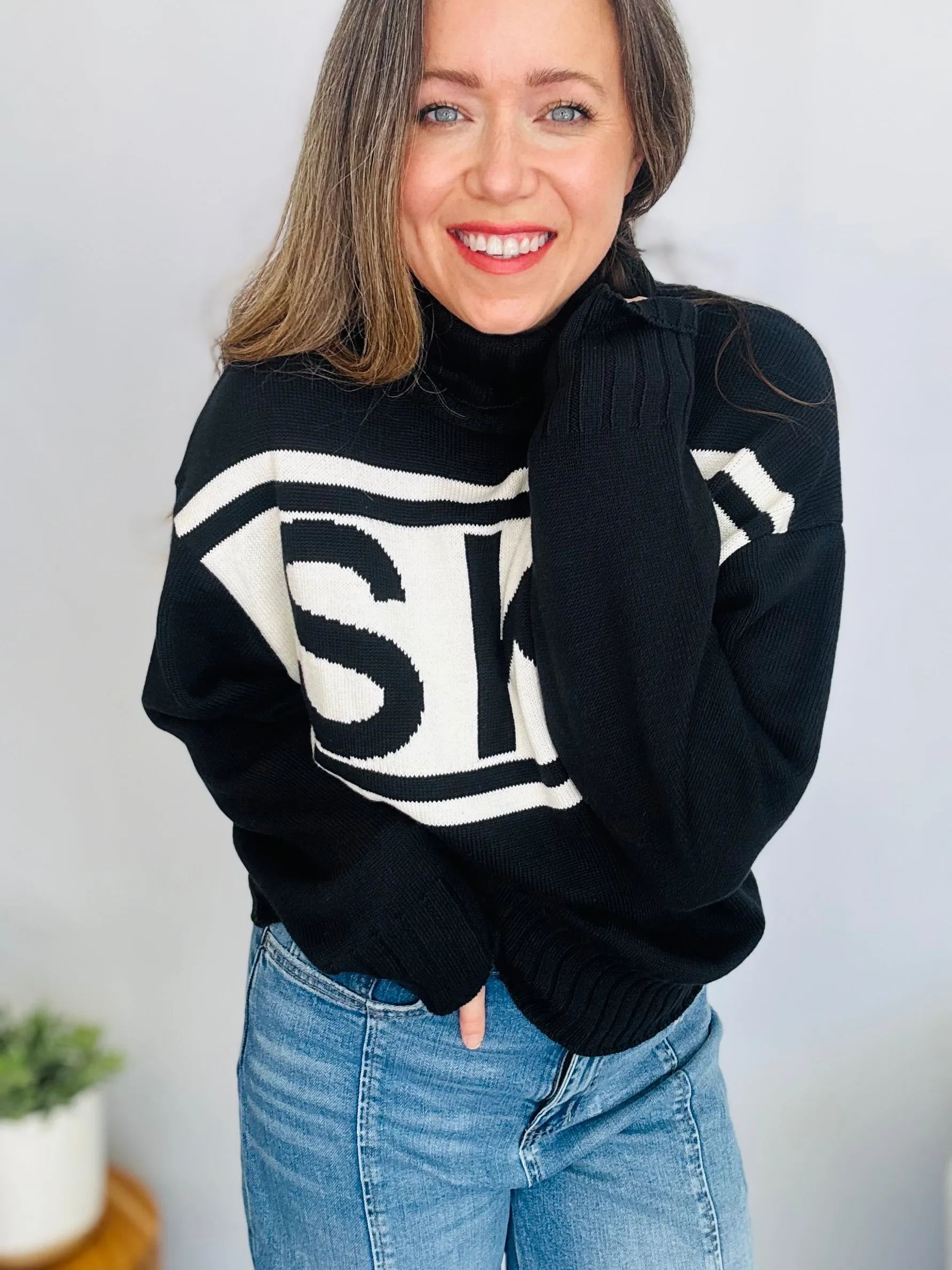 Stay Cozy in Style with the SKI Logo Turtleneck Sweater